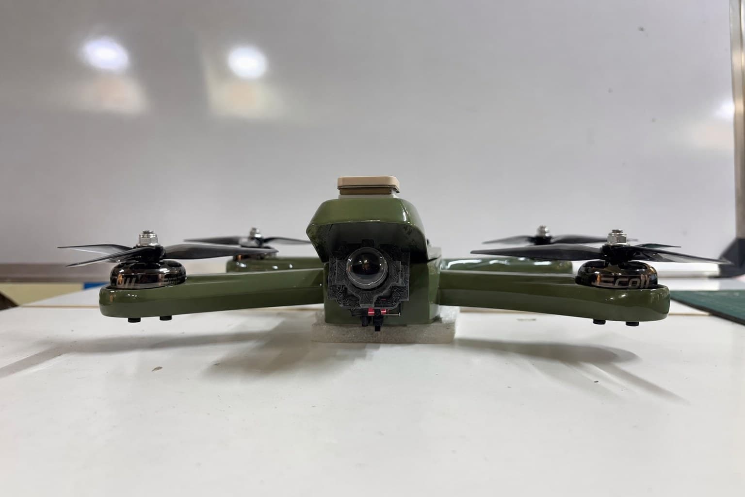 Zeus hybrid-frame FPV trainer, front view showing the FPV camera and GPS mast